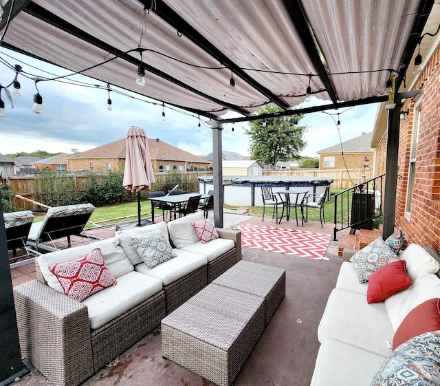 view of patio / terrace with an outdoor hangout area and a shed