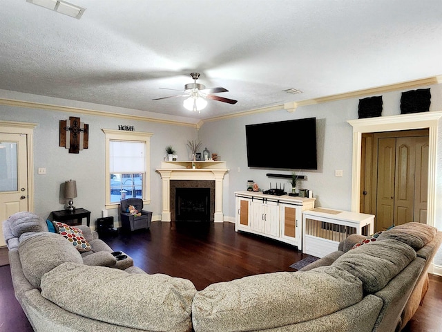 living room featuring a textured ceiling, crown molding, dark hardwood / wood-style floors, and ceiling fan