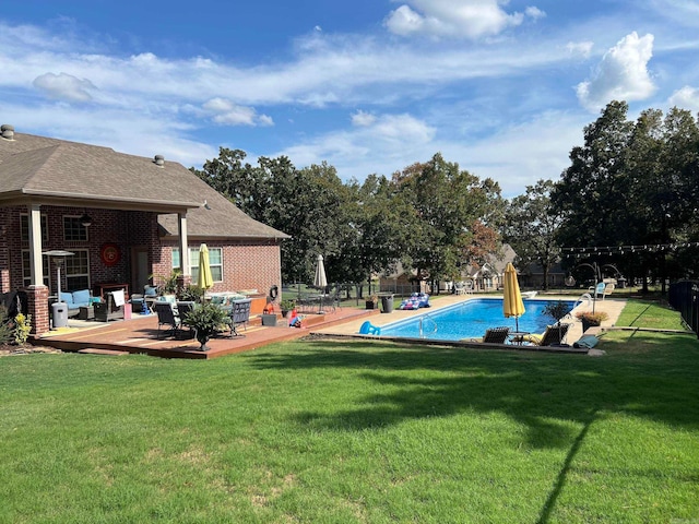 view of swimming pool featuring a wooden deck and a yard