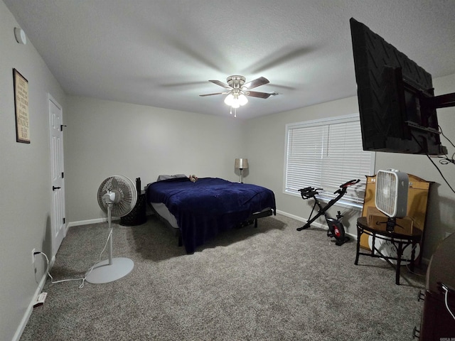 carpeted bedroom featuring ceiling fan and a textured ceiling