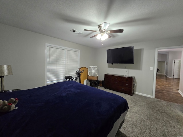 carpeted bedroom with a textured ceiling and ceiling fan