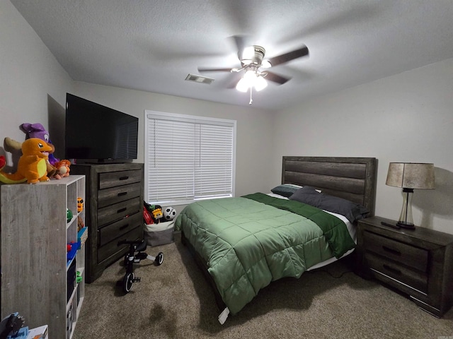 carpeted bedroom with ceiling fan and a textured ceiling