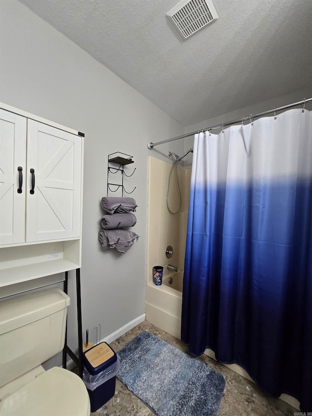 bathroom with shower / tub combo with curtain, concrete flooring, a textured ceiling, and toilet