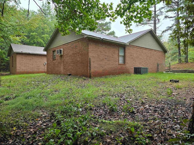 view of side of home featuring central AC