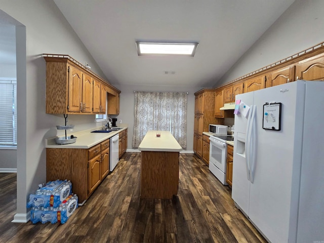 kitchen featuring vaulted ceiling, white appliances, a kitchen island, dark hardwood / wood-style flooring, and sink