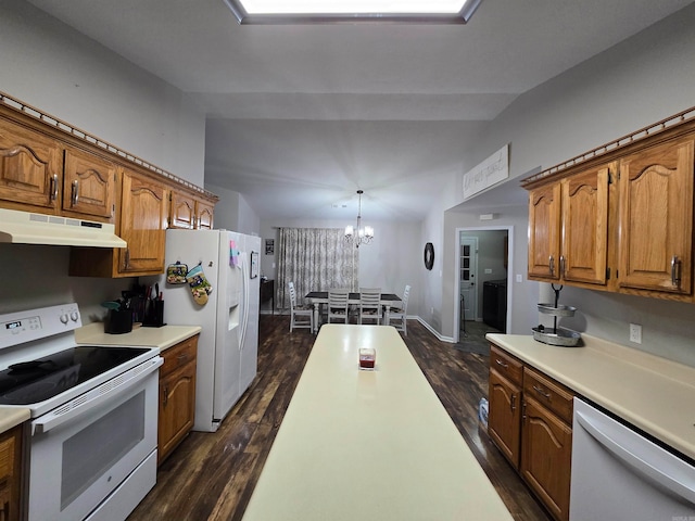 kitchen featuring white appliances, dark hardwood / wood-style floors, a chandelier, and decorative light fixtures