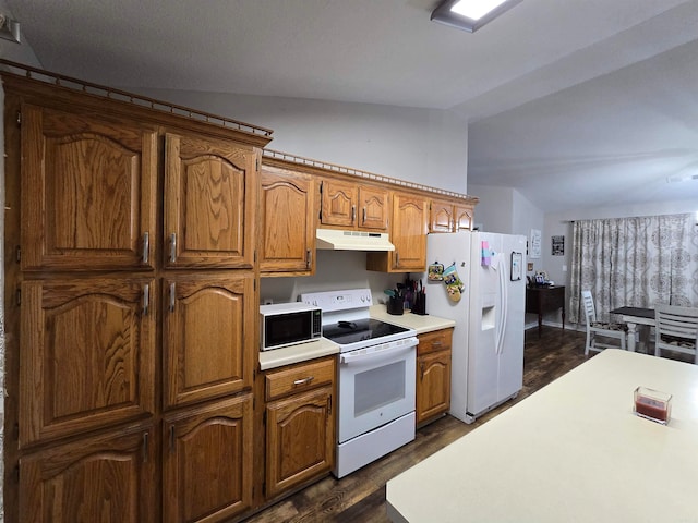 kitchen with lofted ceiling, white appliances, and dark hardwood / wood-style floors