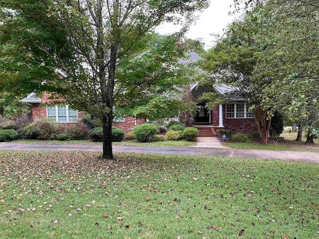 obstructed view of property featuring a front lawn