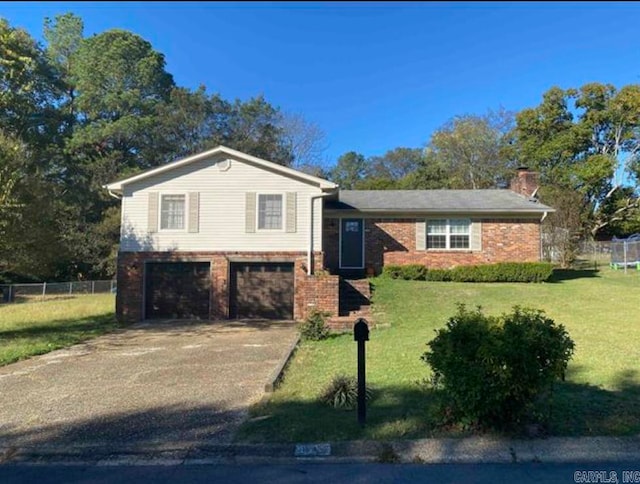 split level home featuring a garage and a front yard