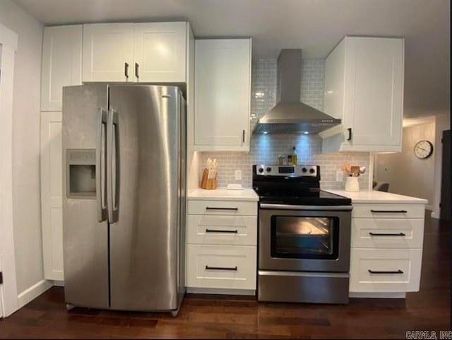 kitchen featuring white cabinets, backsplash, wall chimney exhaust hood, dark hardwood / wood-style flooring, and stainless steel appliances