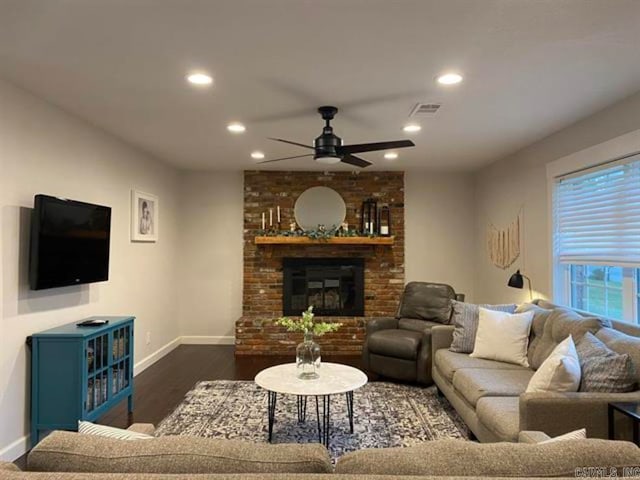 living room featuring a brick fireplace, ceiling fan, and dark hardwood / wood-style flooring