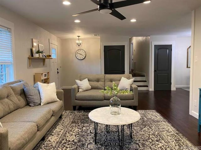 living room featuring dark hardwood / wood-style floors and ceiling fan