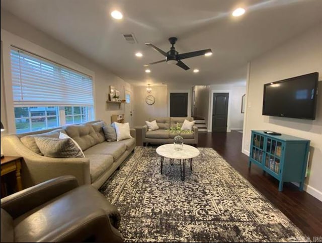 living room featuring ceiling fan and dark hardwood / wood-style flooring