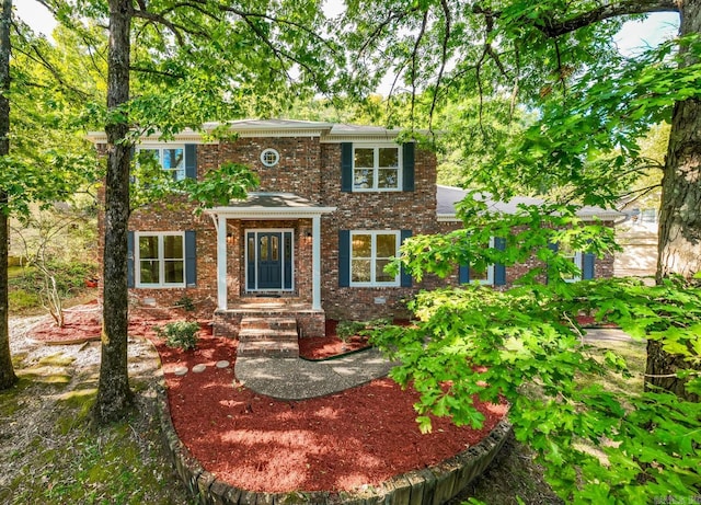 colonial home with brick siding