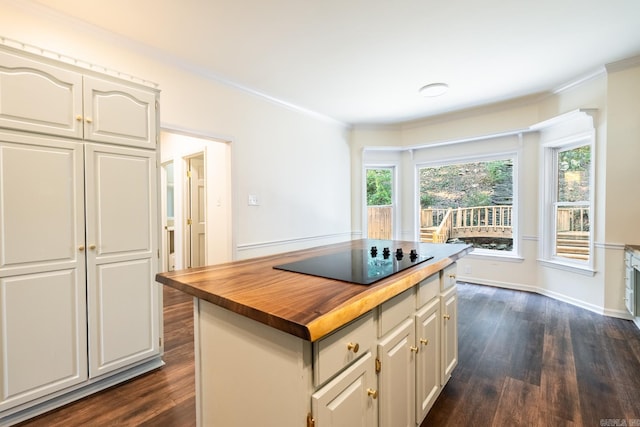 kitchen featuring plenty of natural light, black electric stovetop, wooden counters, and dark wood-style flooring