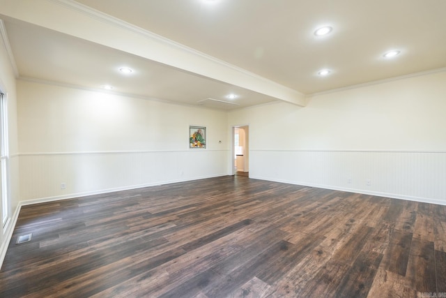 spare room featuring visible vents, dark wood finished floors, a wainscoted wall, ornamental molding, and recessed lighting