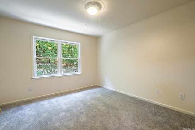 carpeted spare room with baseboards