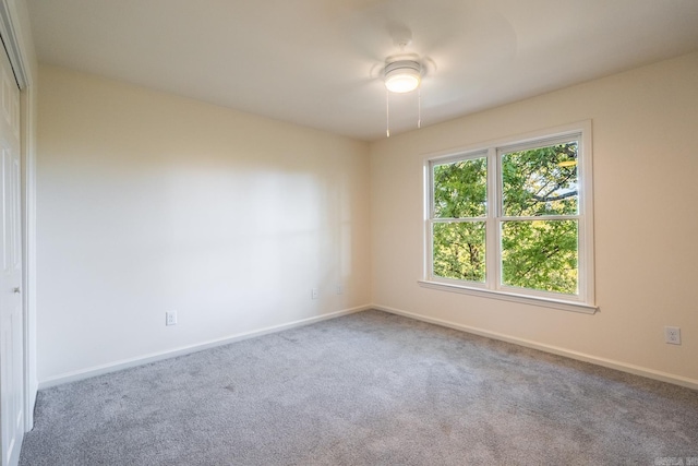 spare room with carpet and baseboards