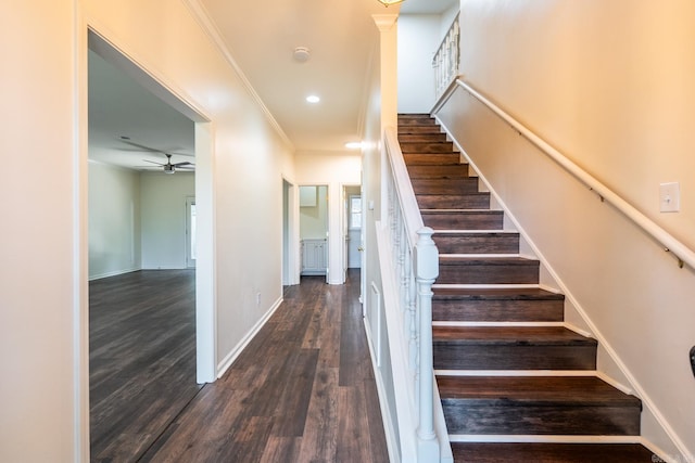 staircase featuring baseboards, ceiling fan, wood finished floors, crown molding, and recessed lighting