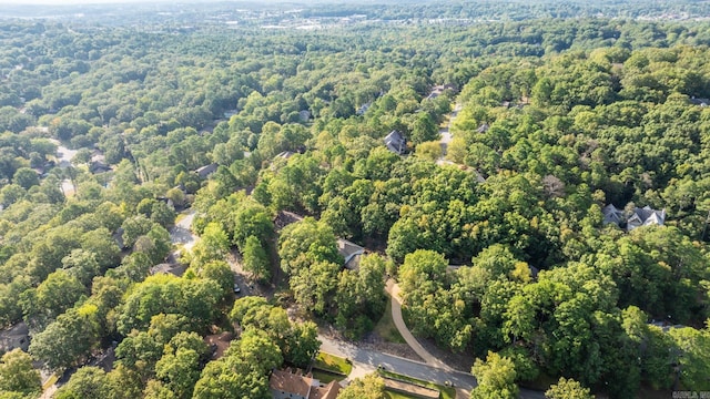 drone / aerial view with a wooded view