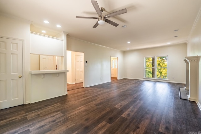 unfurnished living room with ornamental molding, dark wood-type flooring, ceiling fan, and baseboards