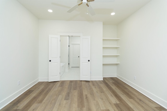 unfurnished bedroom with ceiling fan and light hardwood / wood-style flooring