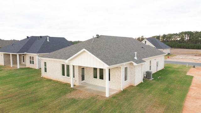 rear view of property with a yard, a patio area, and central air condition unit