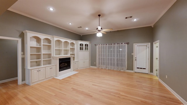 unfurnished living room with light hardwood / wood-style floors, ornamental molding, and ceiling fan