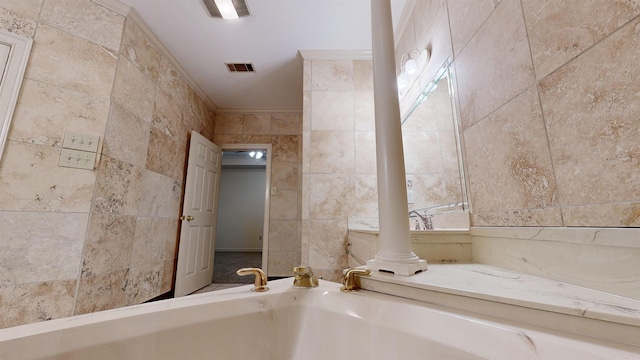 bathroom featuring crown molding and tile walls