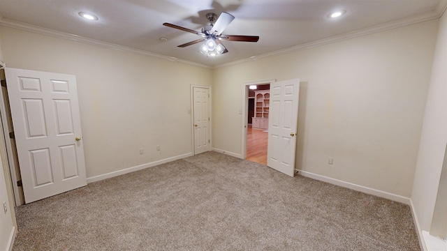 unfurnished bedroom featuring ceiling fan, light carpet, and ornamental molding