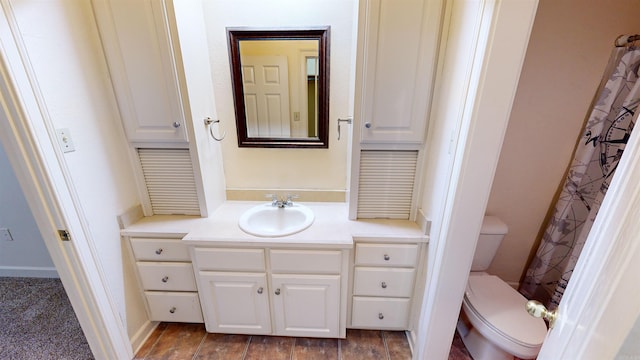 bathroom with walk in shower, vanity, and toilet