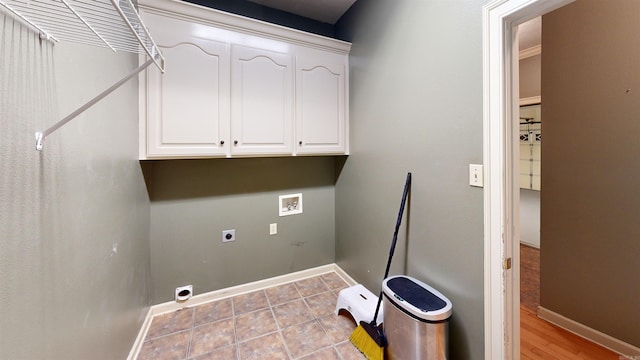 clothes washing area featuring hookup for an electric dryer, washer hookup, and cabinets