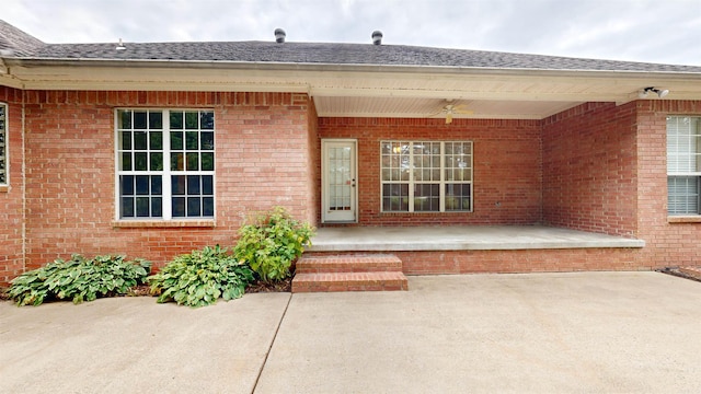 view of exterior entry featuring a patio area