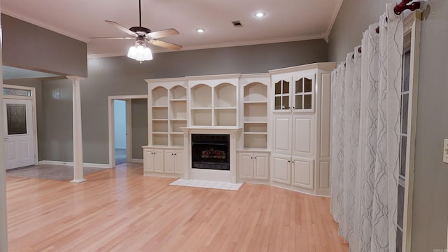 unfurnished living room with ornamental molding, light wood-type flooring, and ceiling fan