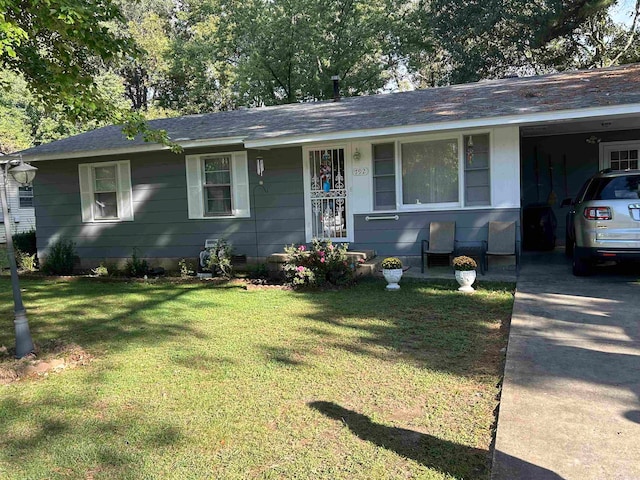 ranch-style home with a front yard and a carport