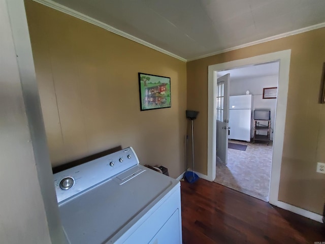 clothes washing area with washer / clothes dryer, dark hardwood / wood-style floors, and crown molding