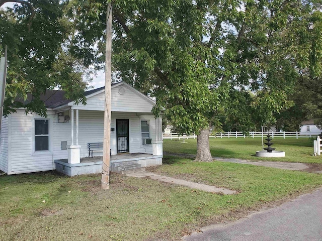 view of front of house featuring a front yard and covered porch