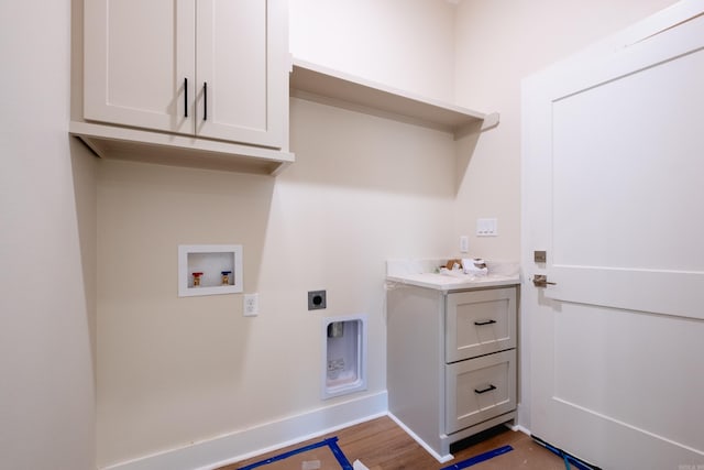 laundry room with washer hookup, electric dryer hookup, wood-type flooring, and cabinets