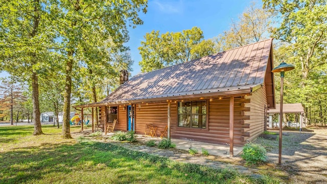 view of property exterior featuring a porch and a yard