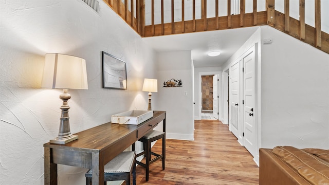 hallway with light hardwood / wood-style flooring