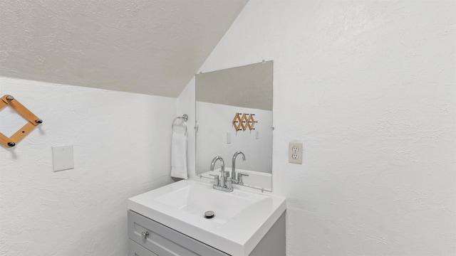 bathroom with vanity and vaulted ceiling