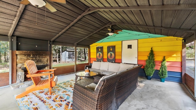 sunroom with ceiling fan and vaulted ceiling