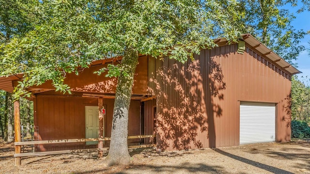 view of front of property featuring a garage and an outbuilding