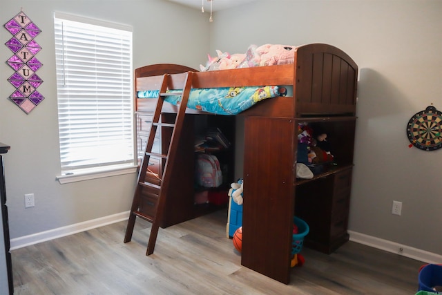 bedroom with hardwood / wood-style flooring