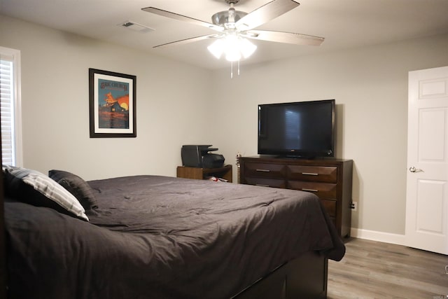 bedroom with light hardwood / wood-style floors and ceiling fan