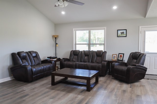 living room featuring wood-type flooring, lofted ceiling, ceiling fan, and a wealth of natural light