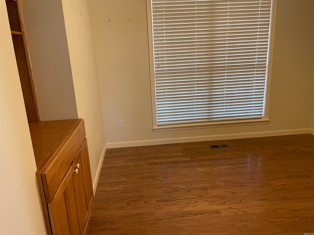 empty room featuring dark wood-type flooring