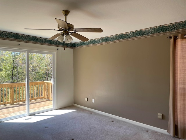 carpeted spare room featuring ceiling fan