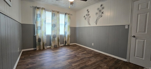 empty room with dark wood-type flooring, ceiling fan, and ornamental molding