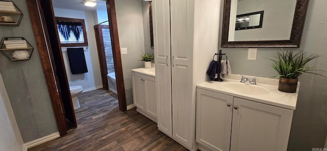 bathroom featuring hardwood / wood-style flooring, vanity, and toilet